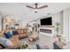 Open concept living area with modern fireplace, ceiling fan, and seamless flow to kitchen at 7211 Ronnie Gardens Ct, Tampa, FL 33619