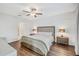 Bright main bedroom with wood floors, paneled accent wall, and a ceiling fan at 7211 Ronnie Gardens Ct, Tampa, FL 33619