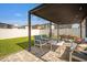 Relaxing covered patio with outdoor furniture, grill, and beautiful pavers for easy entertaining at 7211 Ronnie Gardens Ct, Tampa, FL 33619