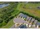 Aerial view of homes nestled by green space featuring tranquil pond at 7302 Sunshine Bridge Ave, Gibsonton, FL 33534