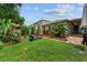 Landscaped backyard with covered patio and plants at 7302 Sunshine Bridge Ave, Gibsonton, FL 33534
