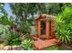 Backyard sauna, waterfall feature, and lush greenery create a serene, private oasis at 7302 Sunshine Bridge Ave, Gibsonton, FL 33534
