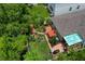 Aerial view of a meticulously landscaped backyard with a firepit and outdoor living space at 7302 Sunshine Bridge Ave, Gibsonton, FL 33534