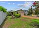 Well-maintained home featuring a brick driveway, green lawn, and partial view of a two-car garage at 7302 Sunshine Bridge Ave, Gibsonton, FL 33534