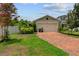 Charming single-Gathering home featuring a brick driveway and a two-car garage in a residential neighborhood at 7302 Sunshine Bridge Ave, Gibsonton, FL 33534