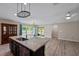 Spacious kitchen featuring an island with granite countertops, stainless steel appliances, and wood flooring at 7302 Sunshine Bridge Ave, Gibsonton, FL 33534