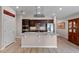 Bright, modern kitchen boasts stainless steel appliances, granite countertops, and dark cabinetry at 7302 Sunshine Bridge Ave, Gibsonton, FL 33534