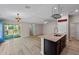 Open-concept kitchen features an island with granite countertops and stainless steel faucet at 7302 Sunshine Bridge Ave, Gibsonton, FL 33534