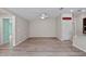 Open-concept living room with hardwood floors, a ceiling fan, and access to other rooms at 7302 Sunshine Bridge Ave, Gibsonton, FL 33534