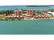 Stunning aerial view of waterfront condos and pier access with a serene ocean backdrop at 7432 Sunshine Skyway S Ln # 402, St Petersburg, FL 33711