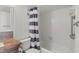 Bathroom featuring white tile shower and striped shower curtain at 7432 Sunshine Skyway S Ln # 402, St Petersburg, FL 33711