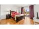 Bedroom featuring a balcony with a view and a dark wood bed frame at 7432 Sunshine Skyway S Ln # 402, St Petersburg, FL 33711