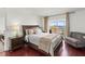 Bedroom with hardwood floors and a balcony with a water view at 7432 Sunshine Skyway S Ln # 402, St Petersburg, FL 33711