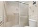 Updated shower with glass doors, tile surround, and a built-in bench at 7432 Sunshine Skyway S Ln # 402, St Petersburg, FL 33711