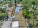 Aerial view of the home with a fenced yard, parking area, and mature trees offering shade and privacy to the property at 750 49Th N Ave, St Petersburg, FL 33703