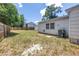 Back yard with grass and a wood fence, surrounded by mature trees at 750 49Th N Ave, St Petersburg, FL 33703