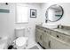 Bathroom featuring updated vanity, toilet, shower, and bright natural light at 750 49Th N Ave, St Petersburg, FL 33703