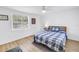 Bright bedroom featuring a ceiling fan, light wood floors, and a large window at 750 49Th N Ave, St Petersburg, FL 33703