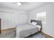 Cozy bedroom with light wood flooring, ceiling fan, and closet for ample storage at 750 49Th N Ave, St Petersburg, FL 33703