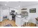 Modern kitchen with white cabinets, granite countertops, stainless steel appliances, and stylish bar seating at 750 49Th N Ave, St Petersburg, FL 33703