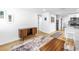 Open-concept living room with modern flooring, stylish furniture, and a view into the updated kitchen at 750 49Th N Ave, St Petersburg, FL 33703