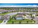 Aerial view showcases a community featuring a pond and manicured lawns, creating a tranquil and inviting atmosphere at 7628 Surf Reed Way, Wesley Chapel, FL 33545