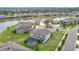 Aerial view of a suburban neighborhood featuring a pond, well-maintained lawns, and neatly arranged homes at 7628 Surf Reed Way, Wesley Chapel, FL 33545