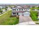 Beautifully landscaped home boasts a spacious three-car garage and a welcoming entrance at 7628 Surf Reed Way, Wesley Chapel, FL 33545