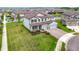 A high angle perspective of a lovely home with a green lawn and view of pond at 7628 Surf Reed Way, Wesley Chapel, FL 33545