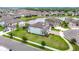 Aerial view capturing the beauty of home overlooking a pond, enhanced by vibrant green lawns at 7628 Surf Reed Way, Wesley Chapel, FL 33545