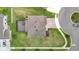 The aerial shot shows a beautiful home with a screened lanai and green lawn in a desirable neighborhood at 7628 Surf Reed Way, Wesley Chapel, FL 33545