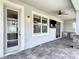 Entertain on this screened patio with a TV and outdoor kitchen at 7628 Surf Reed Way, Wesley Chapel, FL 33545