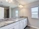Bathroom featuring a double sink vanity with granite counters and large mirror at 7628 Surf Reed Way, Wesley Chapel, FL 33545