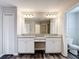 Bathroom with double vanity, granite countertops and a framed mirror at 7628 Surf Reed Way, Wesley Chapel, FL 33545
