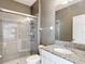 Bathroom featuring a tiled shower with glass doors and granite vanity at 7628 Surf Reed Way, Wesley Chapel, FL 33545