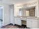 Bathroom with double vanity, granite countertops and a framed mirror at 7628 Surf Reed Way, Wesley Chapel, FL 33545