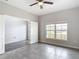 Bedroom with tile flooring, ceiling fan, and an open doorway leading to another room at 7628 Surf Reed Way, Wesley Chapel, FL 33545