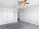 Comfortable bedroom with a ceiling fan and a view of the neighborhood at 7628 Surf Reed Way, Wesley Chapel, FL 33545