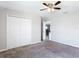 Bedroom featuring a ceiling fan, plush carpet, and a closet with folding doors at 7628 Surf Reed Way, Wesley Chapel, FL 33545