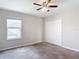 Bedroom with a ceiling fan, plush carpet, and a closet with folding doors at 7628 Surf Reed Way, Wesley Chapel, FL 33545