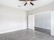 Tile floored room featuring a ceiling fan and a window, with an open doorway to an adjacent room at 7628 Surf Reed Way, Wesley Chapel, FL 33545