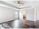 Spacious bedroom featuring vinyl floors, recessed ceilings, and a bathroom entrance at 7628 Surf Reed Way, Wesley Chapel, FL 33545