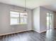 Bright dining area featuring a window, stylish light fixture, and access to the outdoor space at 7628 Surf Reed Way, Wesley Chapel, FL 33545