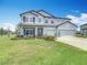 Lovely home featuring an attached three-car garage and a beautiful, green front lawn at 7628 Surf Reed Way, Wesley Chapel, FL 33545