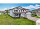 Charming two-story home boasts a spacious three-car garage and well-maintained front yard at 7628 Surf Reed Way, Wesley Chapel, FL 33545
