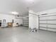 Spacious three car garage with epoxy flooring and ample storage space at 7628 Surf Reed Way, Wesley Chapel, FL 33545