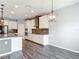 Kitchen view showcasing stainless steel appliances, granite countertops, and white cabinetry in an open layout at 7628 Surf Reed Way, Wesley Chapel, FL 33545
