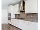 Well-equipped kitchen with granite countertops, stainless steel appliances, and subway tile backsplash at 7628 Surf Reed Way, Wesley Chapel, FL 33545