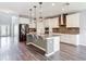 Spacious kitchen featuring stainless steel appliances, granite countertops, and a central island for gathering at 7628 Surf Reed Way, Wesley Chapel, FL 33545