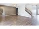 Spacious living room with wood-look flooring, staircase, and an open floor plan at 7628 Surf Reed Way, Wesley Chapel, FL 33545